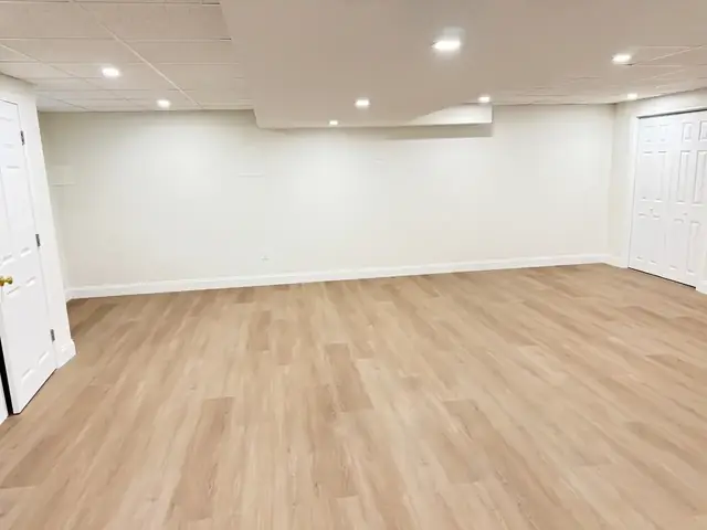 Finished basement with luxury vinyl plank floors and recessed lighting in Chelmsford, MA