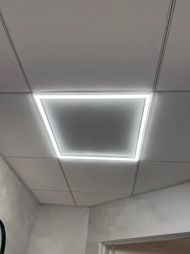 Basement room with drop ceiling and LED panel light