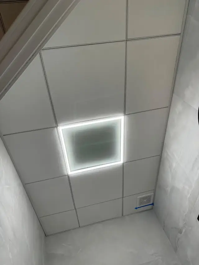 Drop ceiling with LED lighting in a basement room