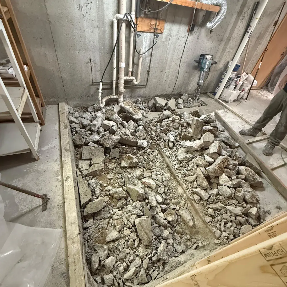 Rough Work: Concrete cut for new plumbing lines, then patched and leveled